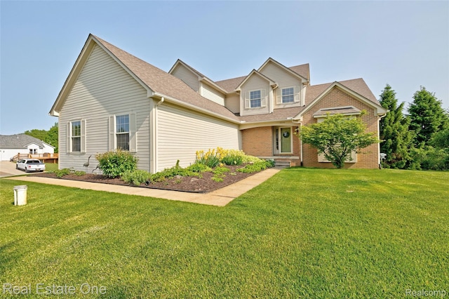 2338 Malena Ln, Oxford, MI 48371 - view of front of house featuring a front lawn, brick siding, and roof with shingles
