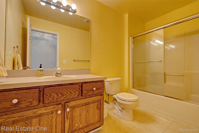 2338 Malena Ln, Oxford, MI 48371 - bathroom with tile patterned flooring, toilet, vanity, and enclosed tub / shower combo