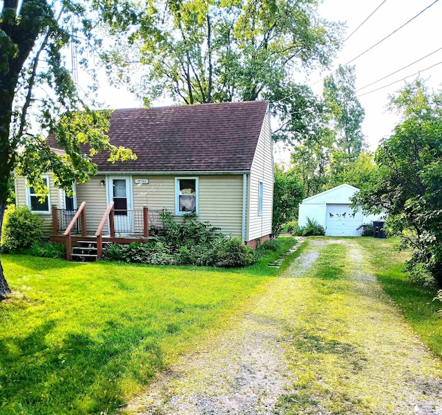 15330 Dayton Rd, Monroe, MI 48161 - cape cod house with a shingled roof, an outdoor structure, a garage, a front lawn, and a wooden deck