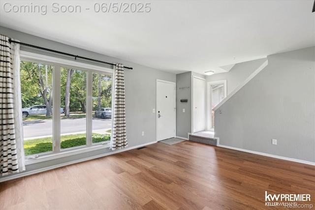 77 Willow Way Unit 13, Waterford, MI 48328 - unfurnished living room with wood finished floors and baseboards