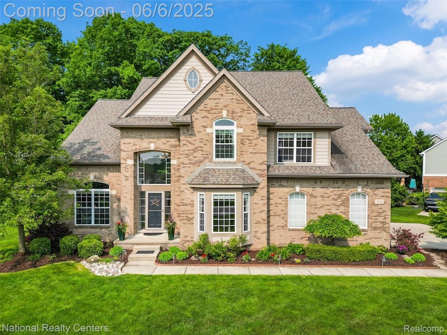 3924 High Grove Way, Lake Orion, MI 48360 - view of front facade featuring roof with shingles, brick siding, and a front lawn
