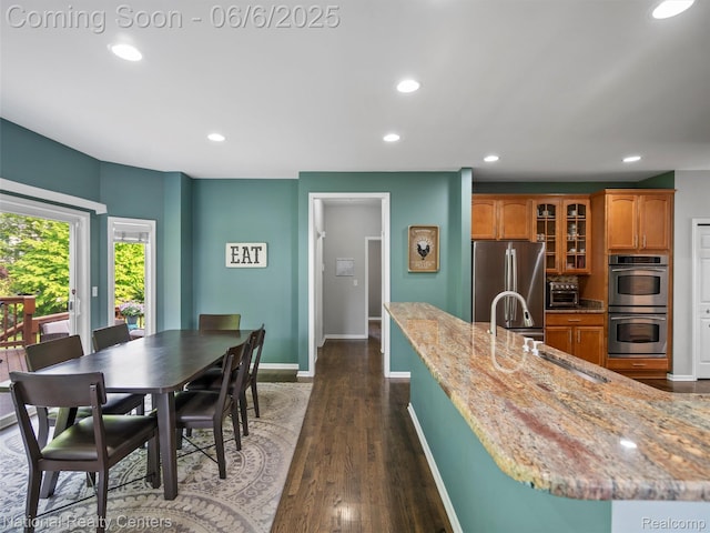 3924 High Grove Way, Lake Orion, MI 48360 - kitchen with stainless steel appliances, recessed lighting, brown cabinets, baseboards, and glass insert cabinets