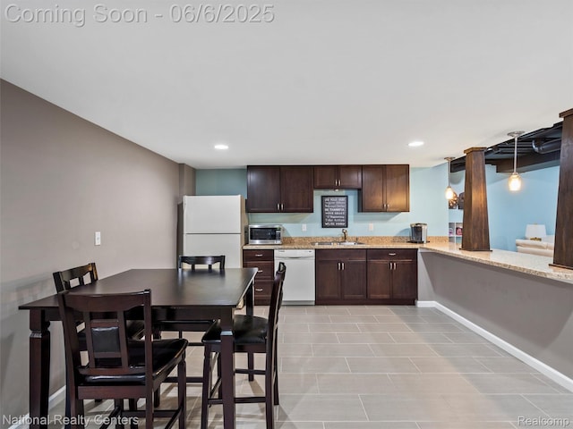 3924 High Grove Way, Lake Orion, MI 48360 - kitchen featuring white appliances, dark brown cabinetry, a sink, recessed lighting, and light stone counters