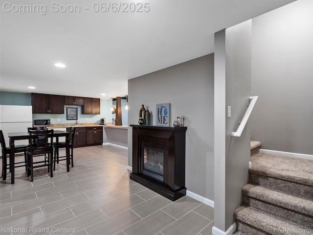 3924 High Grove Way, Lake Orion, MI 48360 - dining space featuring recessed lighting, baseboards, stairs, a glass covered fireplace, and wood tiled floors