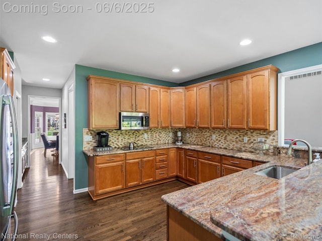 3924 High Grove Way, Lake Orion, MI 48360 - kitchen with a sink, appliances with stainless steel finishes, dark wood finished floors, light stone counters, and decorative backsplash