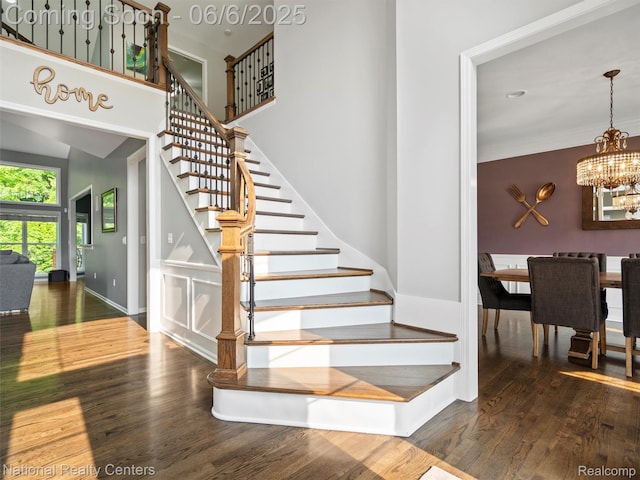 3924 High Grove Way, Lake Orion, MI 48360 - stairway featuring wood finished floors, a chandelier, a towering ceiling, and baseboards