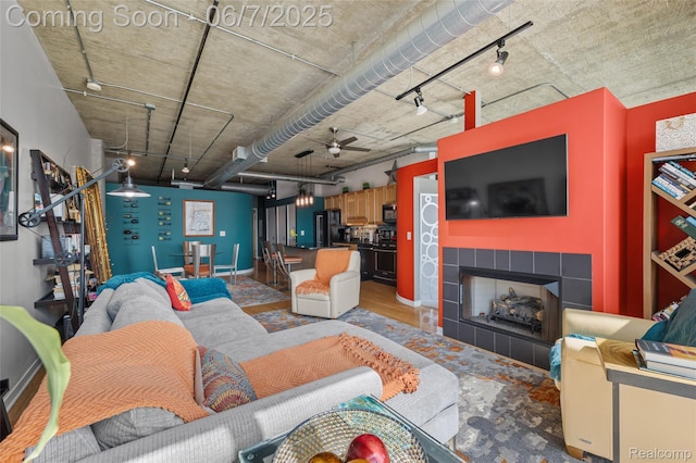 100 W 5th St Unit 504, Royal Oak, MI 48067 - living room featuring ceiling fan, rail lighting, and a tiled fireplace