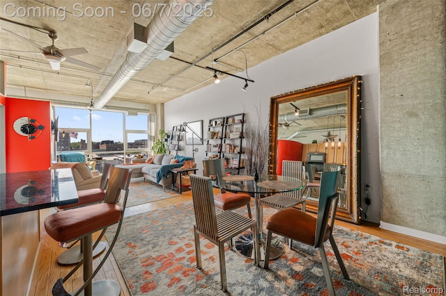 100 W 5th St Unit 504, Royal Oak, MI 48067 - dining area featuring wood finished floors, a ceiling fan, and baseboards