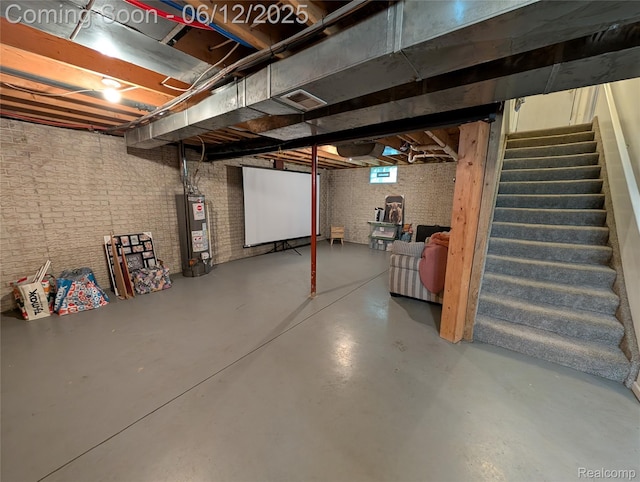 3070 Strong Hts, Grand Blanc, MI 48507 - basement featuring gas water heater, stairs, and brick wall