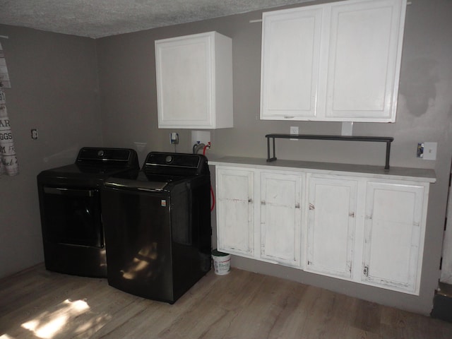 1920 S 15th St, Niles, MI 49120 - laundry area with cabinet space, light wood-type flooring, washer and clothes dryer, and a textured ceiling