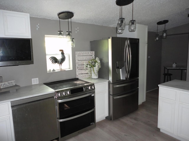 1920 S 15th St, Niles, MI 49120 - kitchen with appliances with stainless steel finishes, a textured ceiling, light wood finished floors, white cabinets, and light countertops