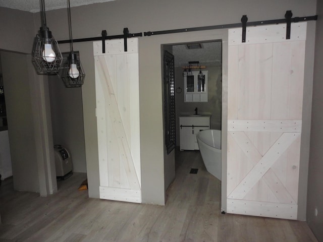 1920 S 15th St, Niles, MI 49120 - interior space with a barn door and light wood-style flooring