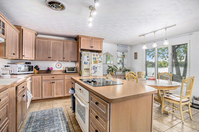 681 Gilead Shores Dr, Bronson, MI 49028 - kitchen featuring white appliances, track lighting, light tile patterned floors, a kitchen island, and pendant lighting