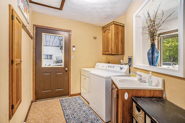 681 Gilead Shores Dr, Bronson, MI 49028 - laundry area featuring cabinet space, washer and dryer, and baseboards