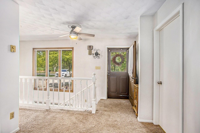 681 Gilead Shores Dr, Bronson, MI 49028 - entrance foyer featuring healthy amount of natural light, light carpet, a ceiling fan, baseboards, and a textured ceiling