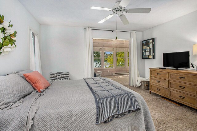 681 Gilead Shores Dr, Bronson, MI 49028 - bedroom featuring light carpet, a baseboard heating unit, and a ceiling fan