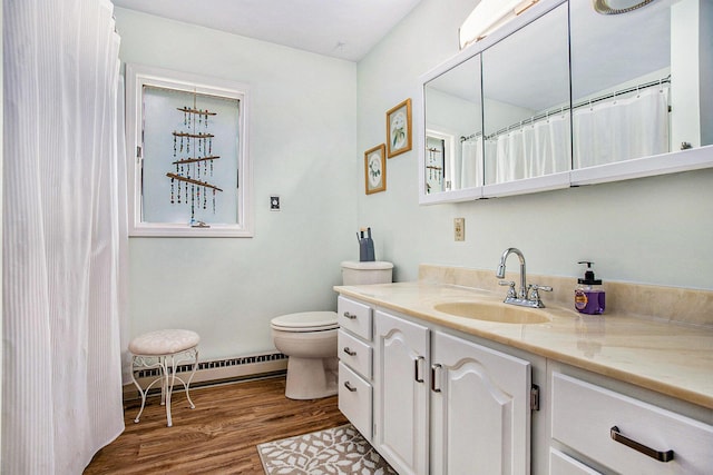 681 Gilead Shores Dr, Bronson, MI 49028 - full bathroom with a baseboard heating unit, vanity, toilet, and wood finished floors