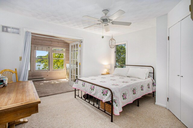 681 Gilead Shores Dr, Bronson, MI 49028 - carpeted bedroom with a baseboard heating unit and ceiling fan