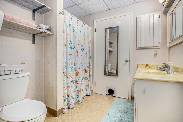 681 Gilead Shores Dr, Bronson, MI 49028 - full bathroom with baseboards, toilet, vanity, a shower with shower curtain, and a drop ceiling