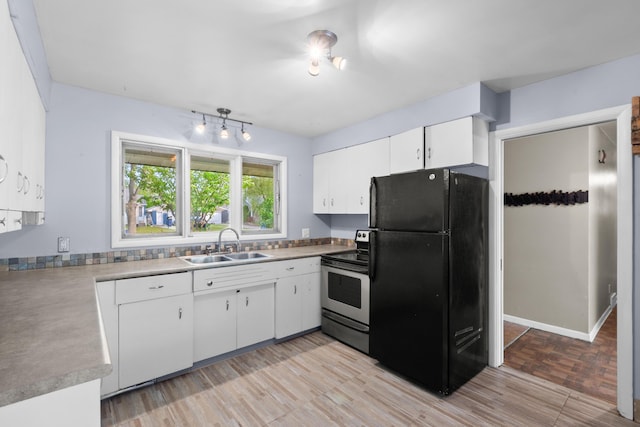 3030 Eastland Rd, Muskegon, MI 49441 - kitchen featuring freestanding refrigerator, electric stove, a sink, white cabinets, and light countertops
