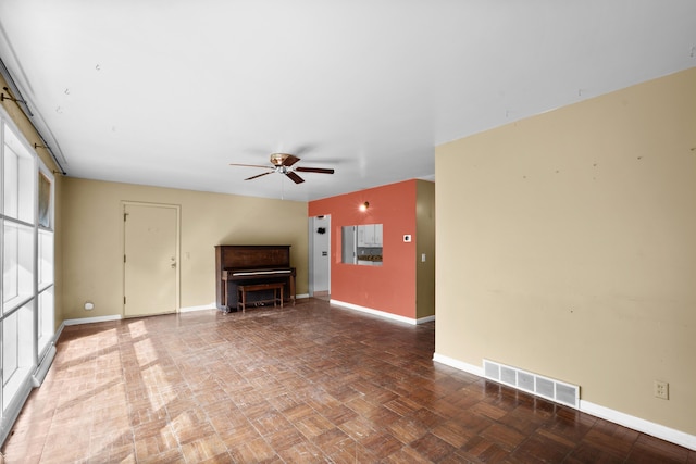 3030 Eastland Rd, Muskegon, MI 49441 - unfurnished living room with baseboards and a ceiling fan