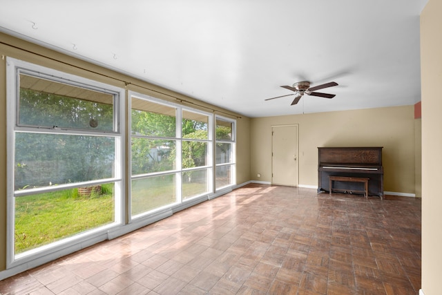 3030 Eastland Rd, Muskegon, MI 49441 - unfurnished living room featuring baseboards and a ceiling fan