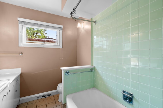 3030 Eastland Rd, Muskegon, MI 49441 - full bathroom featuring a bathtub, vanity, tile patterned flooring, toilet, and baseboards