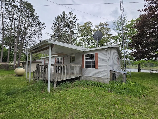 6063 Truman Rd, Barryton, MI 49305 - view of front facade with a front yard, a wooden deck, and central AC unit