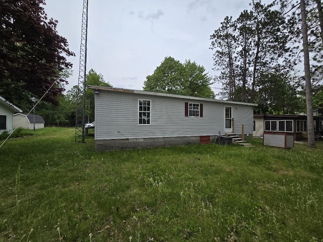 6063 Truman Rd, Barryton, MI 49305 - rear view of property featuring crawl space, entry steps, and a lawn