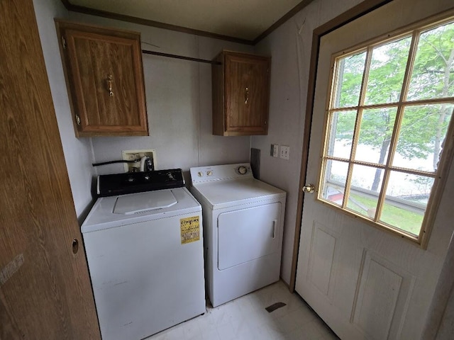 6063 Truman Rd, Barryton, MI 49305 - laundry area featuring cabinet space, washing machine and dryer, healthy amount of natural light, and ornamental molding
