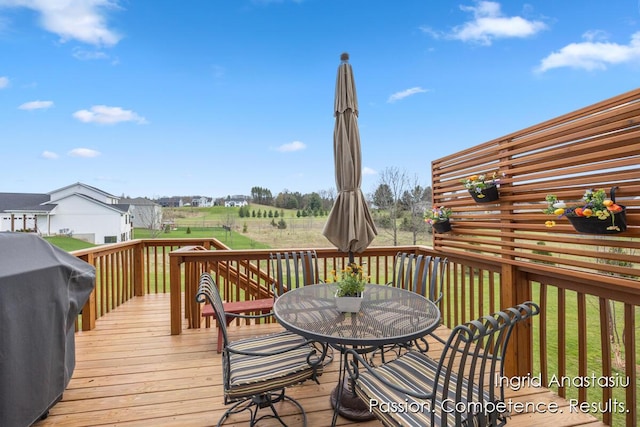 6830 Golden Vw SE, Grand Rapids, MI 49512 - wooden terrace with outdoor dining space, grilling area, and a yard