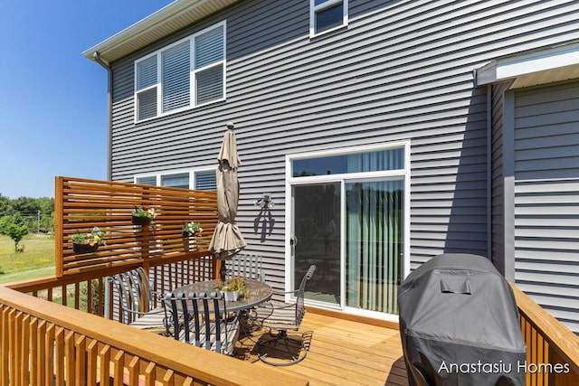 6830 Golden Vw SE, Grand Rapids, MI 49512 - wooden deck featuring a grill and outdoor dining area