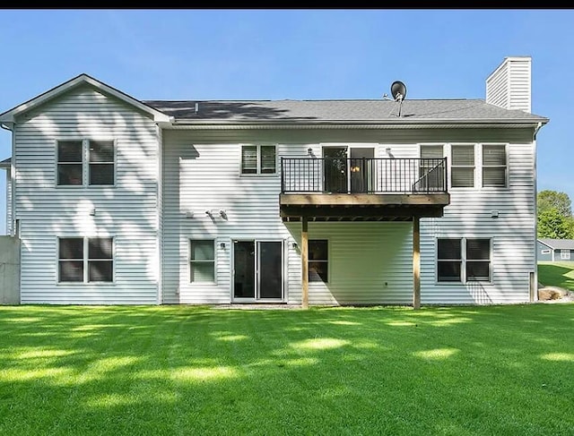4087 Ronalds Rd, Dorr, MI 49323 - back of house featuring a chimney, a lawn, and a wooden deck