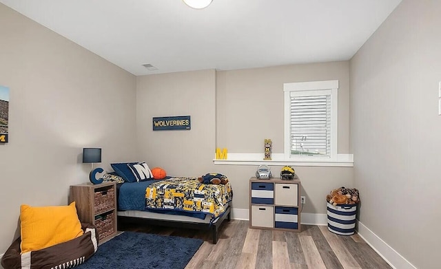 4087 Ronalds Rd, Dorr, MI 49323 - bedroom with wood finished floors and baseboards