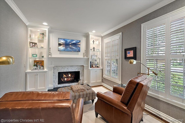 364 Chesterfield Ave, Birmingham, MI 48009 - living room featuring built in shelves, crown molding, a lit fireplace, baseboards, and a textured wall