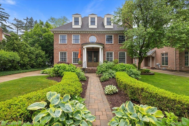 364 Chesterfield Ave, Birmingham, MI 48009 - colonial house featuring french doors, brick siding, and a front yard