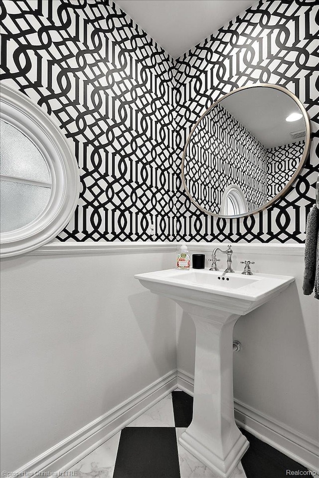 364 Chesterfield Ave, Birmingham, MI 48009 - bathroom featuring marble look tile flooring and wallpapered walls