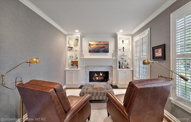 364 Chesterfield Ave, Birmingham, MI 48009 - living area featuring crown molding, a warm lit fireplace, baseboards, built in shelves, and a textured wall