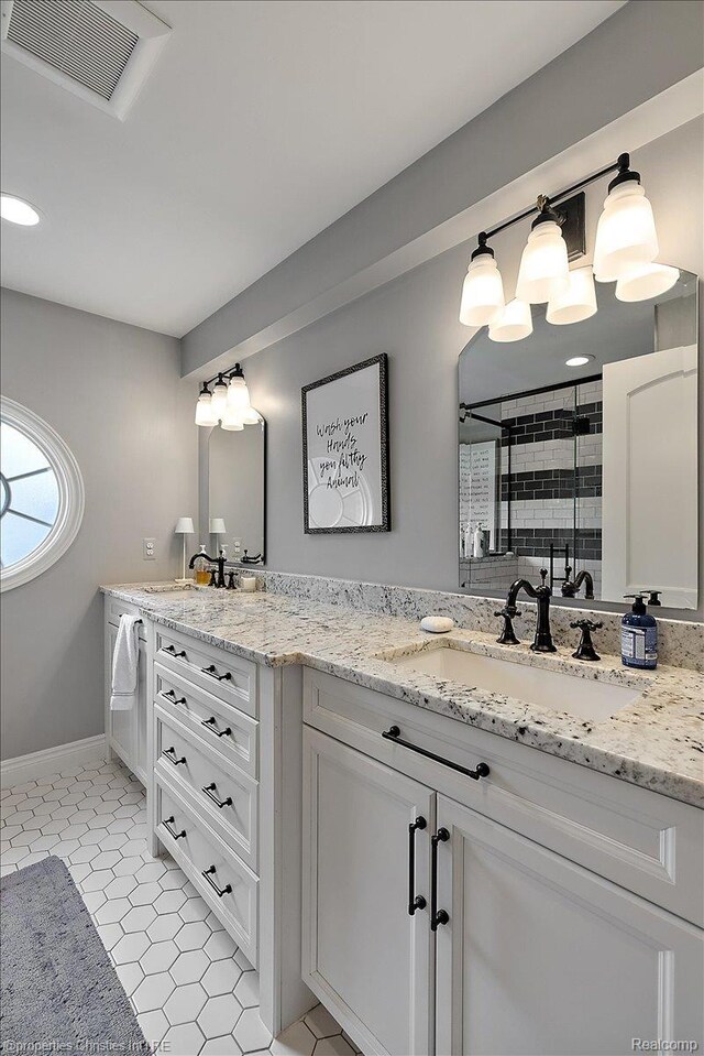 364 Chesterfield Ave, Birmingham, MI 48009 - bathroom featuring double vanity, a shower stall, baseboards, and tile patterned flooring