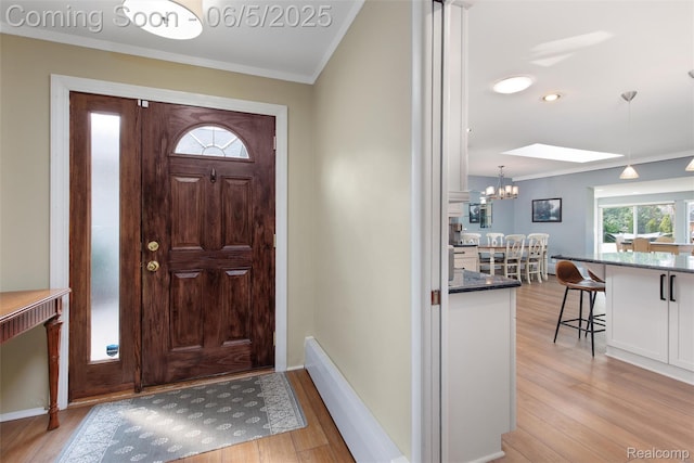 5908 Burnham Rd, Bloomfield Hills, MI 48302 - foyer featuring ornamental molding, light wood finished floors, a chandelier, and baseboards