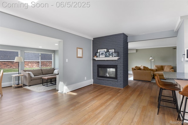 5908 Burnham Rd, Bloomfield Hills, MI 48302 - living room with wood-type flooring, baseboards, a fireplace, a wall unit AC, and crown molding