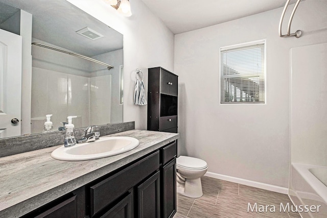 310 Robin Ct, Caledonia, MI 49316 - bathroom with toilet, vanity, baseboards, and  shower combination