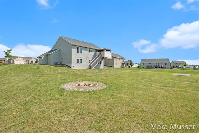 310 Robin Ct, Caledonia, MI 49316 - rear view of property featuring stairs, a yard, and an outdoor fire pit