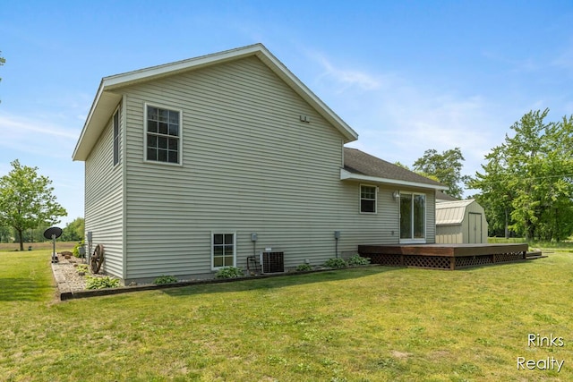 11185 Stanton St, West Olive, MI 49460 - rear view of house with a wooden deck, a yard, and central AC