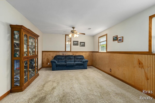 11185 Stanton St, West Olive, MI 49460 - sitting room featuring wainscoting, ceiling fan, carpet floors, and wooden walls