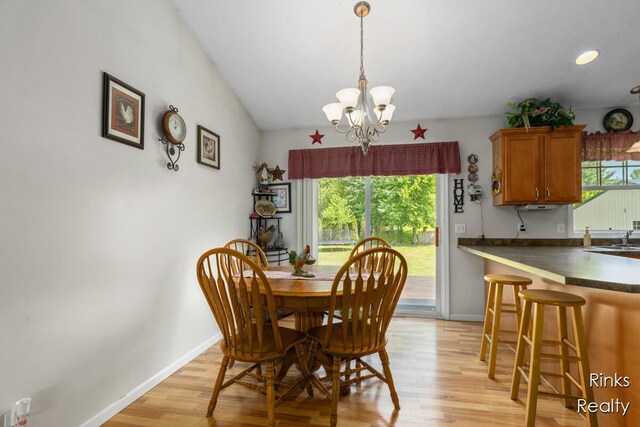11185 Stanton St, West Olive, MI 49460 - dining area with light wood-style floors, baseboards, and a chandelier