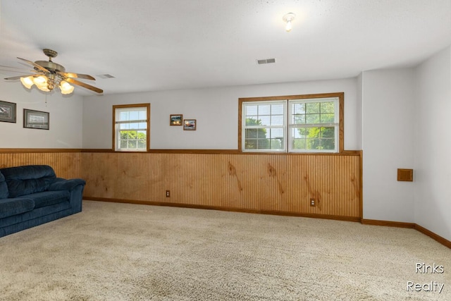 11185 Stanton St, West Olive, MI 49460 - unfurnished room with wainscoting, wooden walls, carpet floors, and a ceiling fan