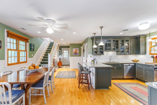 16434 S Basswood Rd, Three Oaks, MI 49128 - kitchen featuring dishwasher, a sink, healthy amount of natural light, light wood-style floors, and a wainscoted wall