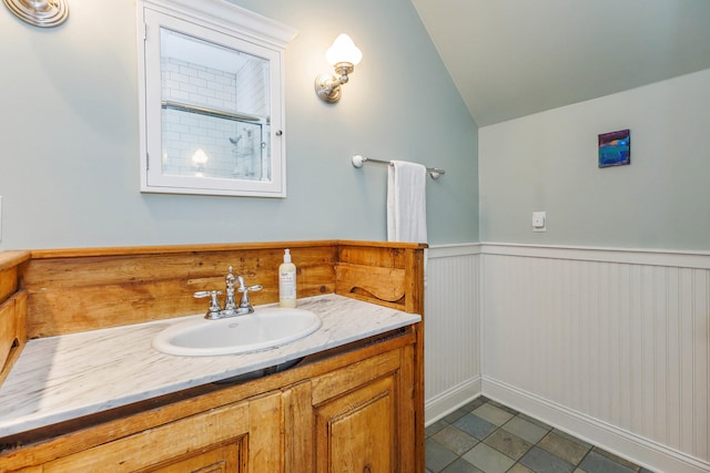 16434 S Basswood Rd, Three Oaks, MI 49128 - full bath featuring vanity, a wainscoted wall, vaulted ceiling, and a shower