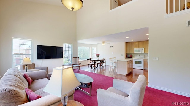 71 Grandview Cir, White Lake, MI 48386 - living area featuring a high ceiling, baseboards, ceiling fan, and recessed lighting